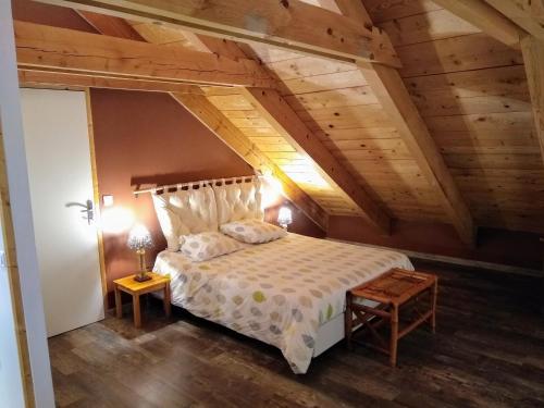 a bedroom with a large bed in a attic at La Grange de l'Ardeyrol in Saint-Clément