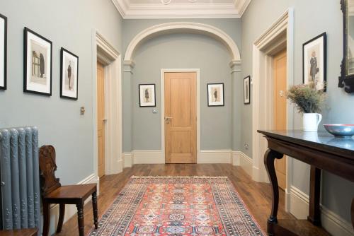 a hallway with a door and a rug at Apartment 1 The Grove in Durham