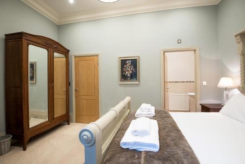 a bedroom with a bed with two towels on it at Apartment 1 The Grove in Durham