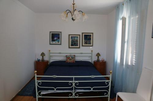 a bedroom with a bed and a chandelier at Haus Judith in Steindorf am Ossiacher See