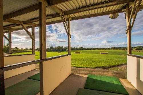 an empty building with a view of a green field at Mendip Spring Golf and Country Club in Churchill