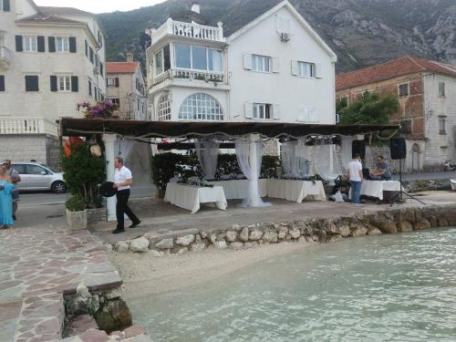 a group of people standing in front of a building at Apartments Vila Marija in Kotor