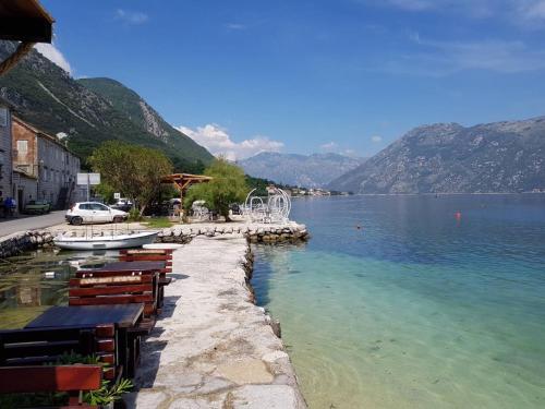a view of a lake with tables and chairs at Apartments Vila Marija in Kotor