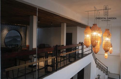 a balcony with chairs and chandeliers in a building at Chang Palace Vientiane in Vientiane