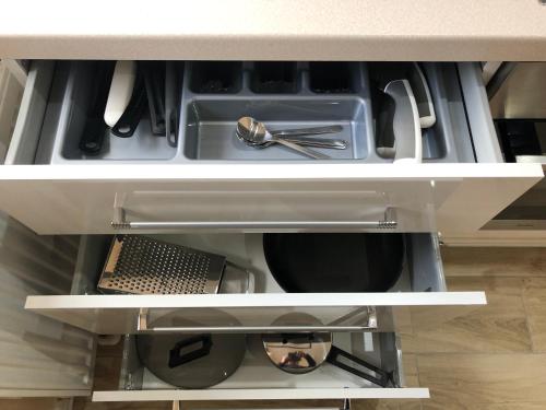 an open drawer with utensils in a kitchen at Apartamenty ALICJA in Dzierżoniów