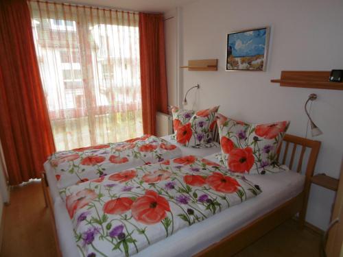 バーベにあるRügenfelsenのベッドルーム1室(赤い花のベッド1台付)
