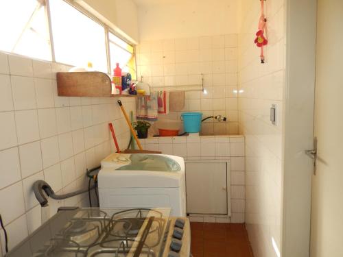 uma pequena cozinha com uma máquina de lavar roupa em APTº EM OLINDA CASA CAIADA em Olinda