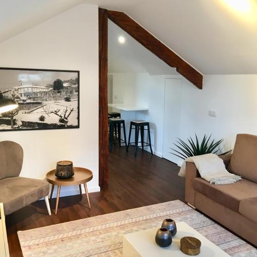 a living room with a couch and a table at Casas Rosa Sousa in Felgueiras
