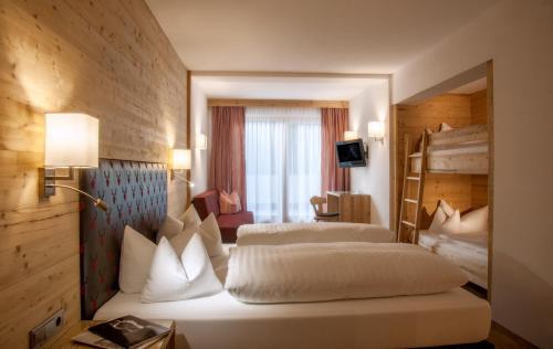a hotel room with two beds and a window at Hotel Tipotsch in Stumm