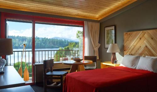 a hotel room with a bed and a large window at Lake House at High Peaks Resort in Lake Placid