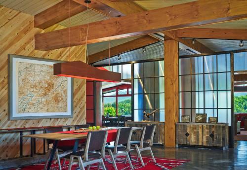 a dining room with a table and chairs at Lake House at High Peaks Resort in Lake Placid