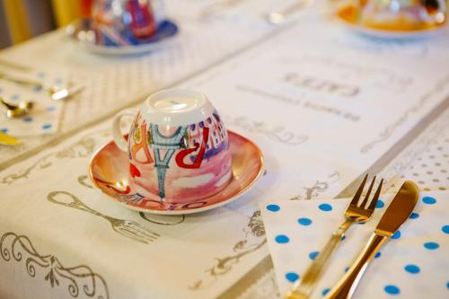 a cup on a plate on a table with a fork at B&B Corte Dal Colle in Caldiero