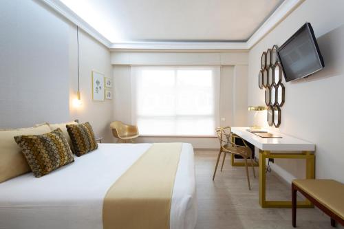 Postel nebo postele na pokoji v ubytování Hotel Ciudad de Vigo