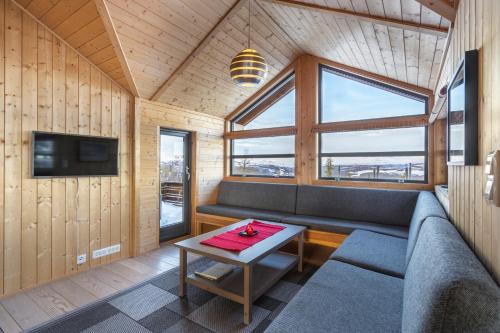 a living room with a couch and a table at Liapark in Ål