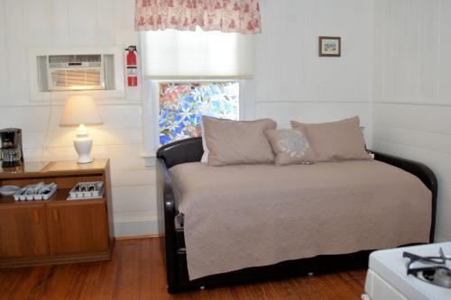 a bedroom with a bed and a table with a lamp at Blackbeard's Lodge in Ocracoke