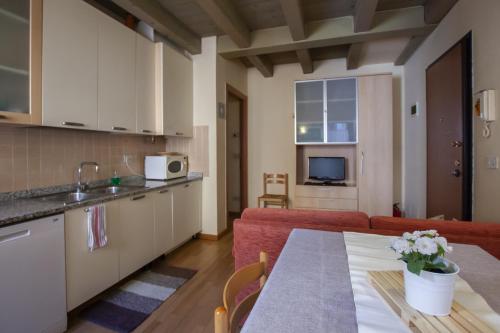 a kitchen and a living room with a table at Venice Apartment in Venice