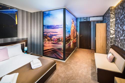 a hotel room with a bed and a couch at Central Point Boutique Hotel in Sofia