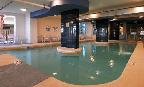 a swimming pool in a hotel with chairs and tables at Seaside Resort by Capital Vacations in Myrtle Beach