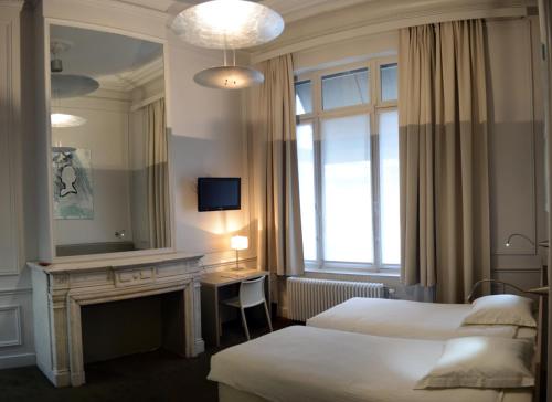 Säng eller sängar i ett rum på Hotel Du Congres