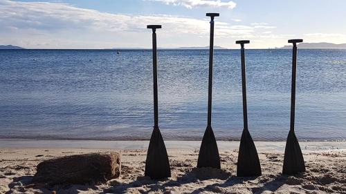three umbrellas in the sand on the beach at Hôtel La Bastide in Hyères