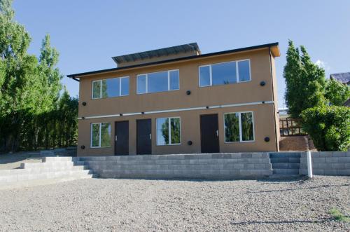 a large house with a lot of windows at Flamenco Bay Apartments in El Calafate