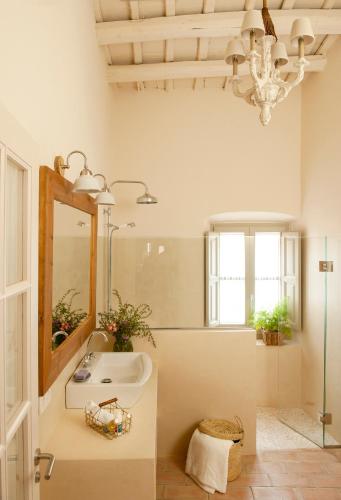 a bathroom with a sink and a mirror at Arkhé Hotel Boutique Pals in Pals