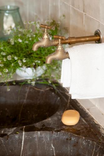 a bathroom sink with a roll of toilet paper at Arkhé Hotel Boutique Pals in Pals