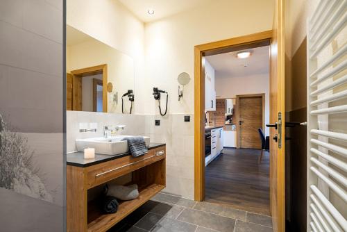 a bathroom with a sink and a mirror at Alpin Chalet am Burgsee in Ladis