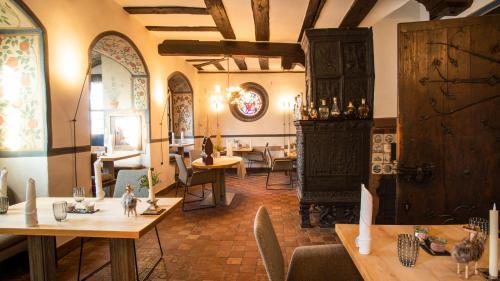 a restaurant with tables and chairs in a room at Restaurant & ****Hotel HÖERHOF in Idstein