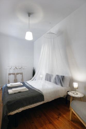 a bedroom with a bed with a mosquito net at 1924 in Lisbon