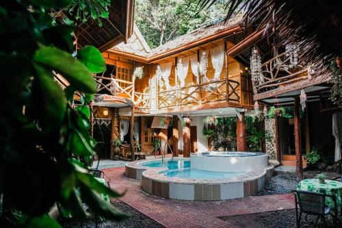 a house with a pool in the middle of a courtyard at Natura Vista in Panglao