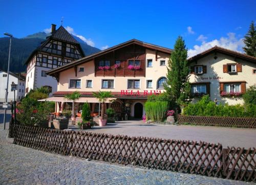 a large building with a fence in front of it at B&B Bela Riva in Savognin