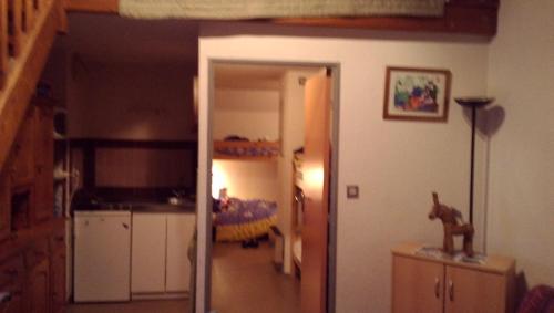 a room with a hallway with a kitchen and a room with at les goutilles in Sainte-Marie-de-Campan