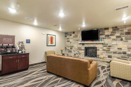 a living room with a couch and a fireplace at Cobblestone Inn & Suites - Bridgeport in Bridgeport