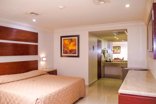 a bedroom with a bed and a bathroom at La Siesta Hotel in Hermosillo