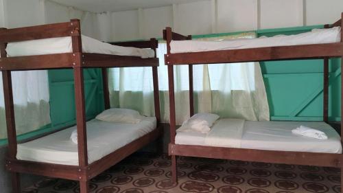 a couple of bunk beds in a room at Life for Life Hostel Drake Bay Home of Sea Turtle Marine Conservation Project Osa Peninsula near San Josecito Beach in Drake
