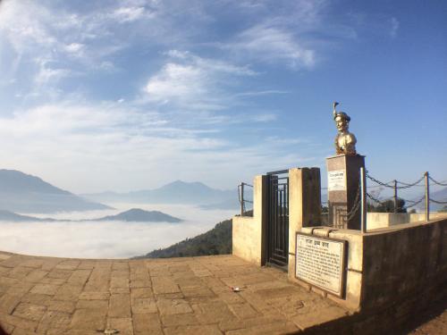 a view from the top of a mountain with clouds at Gorkha Chhen bed & breakfast in Gorkhā