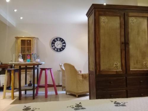 a living room with a large wooden cabinet and a table at Aparts de los Pajaros in El Calafate