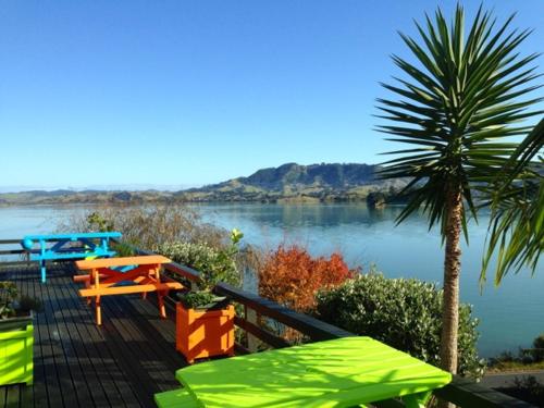 a wooden deck with a view of a river at Pacific Harbour Lodge in Whangaroa