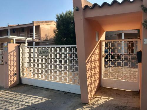 a gate to a house with a fence at Casa Limone in Quartu sant Elena, Capitana, with sea view! in Capitana