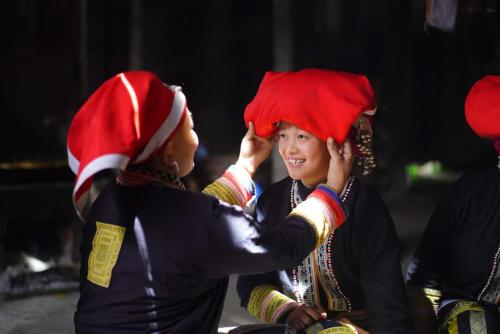two women wearing christmas hats on their heads at Nobita Homestay bắc hà in Bắc Hà