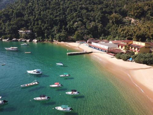 a group of boats in the water next to a beach at Casarao da Praia in Praia Vermelha