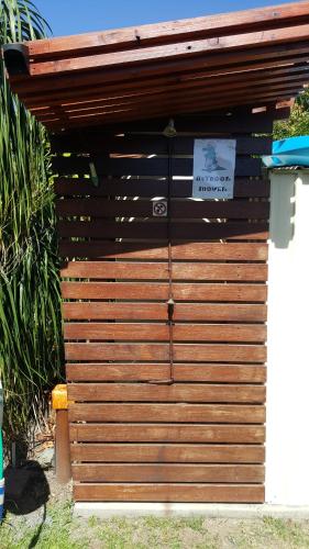 a wooden shed with a sign on it at Seaforth Holiday Units in Seaforth