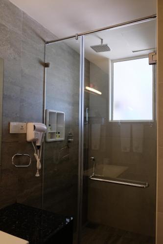 a bathroom with a shower with a glass door at Twenty-Two Weligambay in Weligama