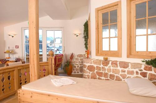 a room with a table and a stone wall at Hotel Sportalm in Gerlos