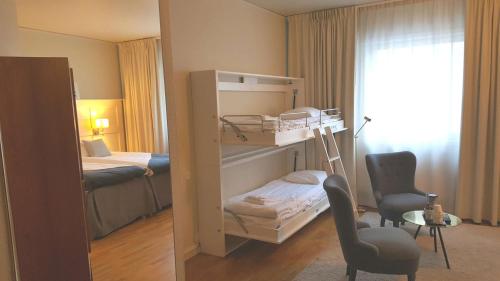 a bedroom with a bunk bed and a bedroom with a bed at Best Western Hotel Baltic in Sundsvall