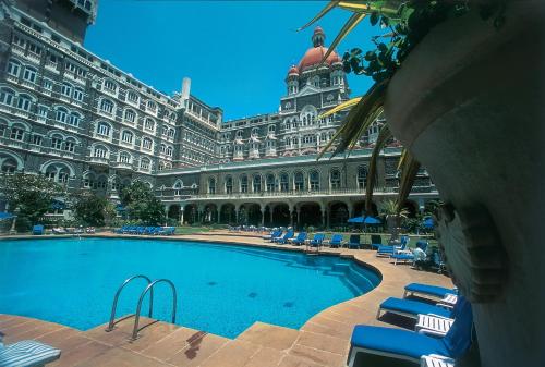 a large building with a swimming pool in front of it at The Taj Mahal Tower, Mumbai in Mumbai