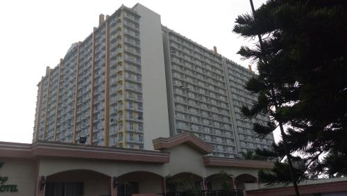 a large white apartment building with a building at Happynest Staycation Family Room 52 in Tagaytay