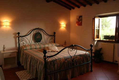 a bedroom with a bed in a room with a window at Case Coloniche Berni in Impruneta