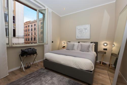 Postel nebo postele na pokoji v ubytování 126 Gracchi Suites